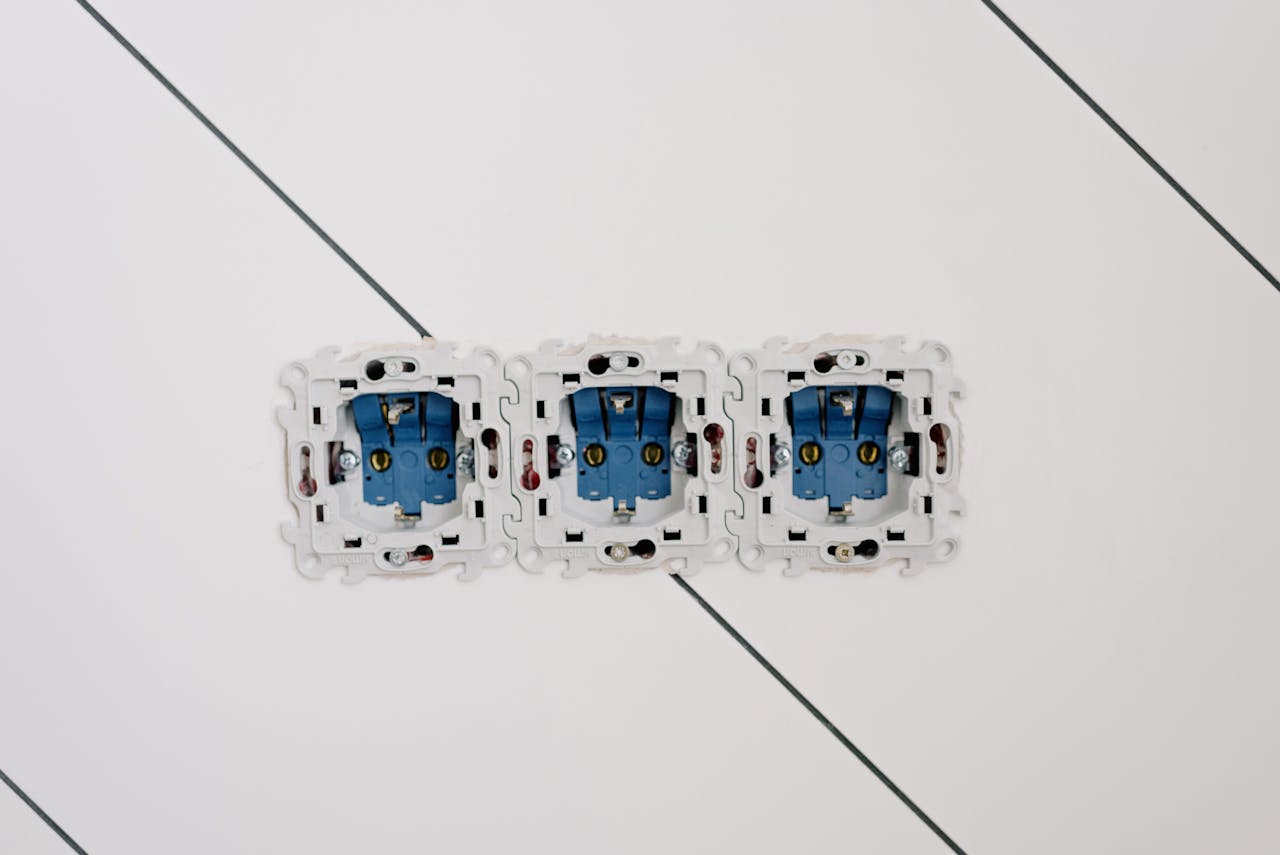why-choose-us-02 Power sockets with various connectors and bolts on wall in room at home